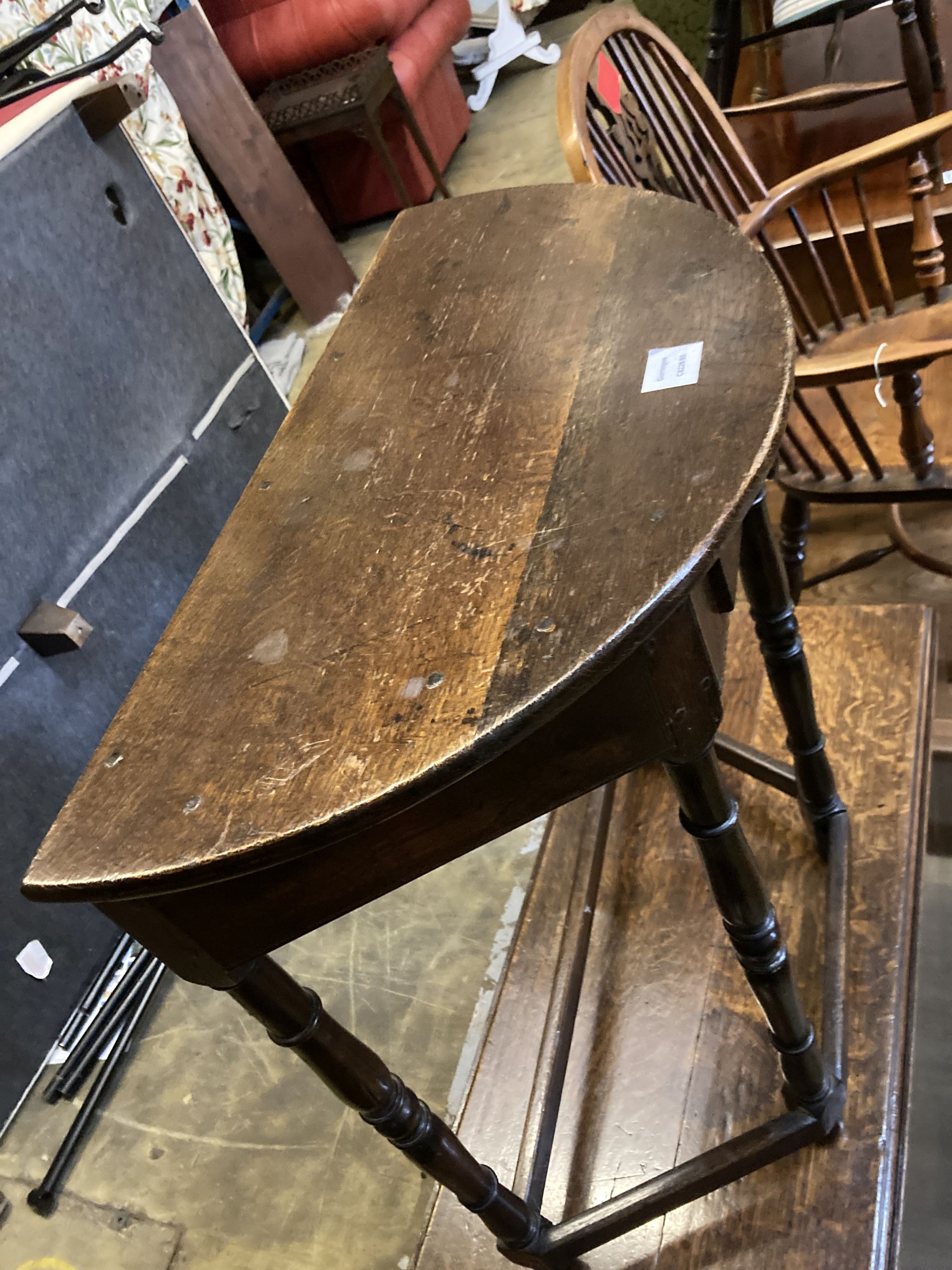 A 18th century style D shaped oak side table, width 68cm, depth 35cm, height 76cm